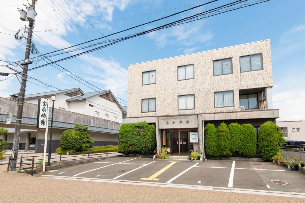 an empty parking lot in front of a building at Houei Ryokan in Fukui