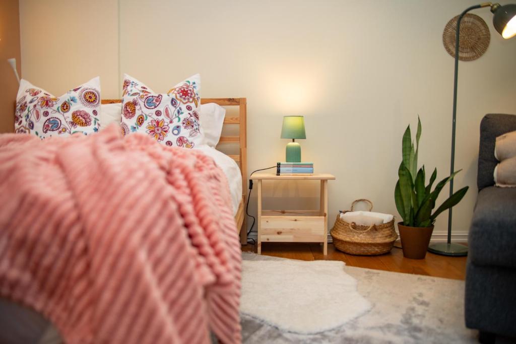 a bedroom with a bed and a table with a lamp at Quiet Nature Studio in Lahemaa, Garden, Terrace and pet friendly in Kolga