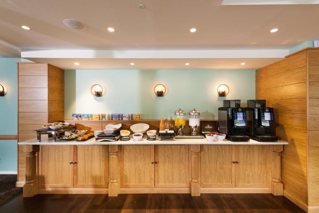 a kitchen with a counter with food on it at Leonardo Inn Aberdeen Airport in Dyce