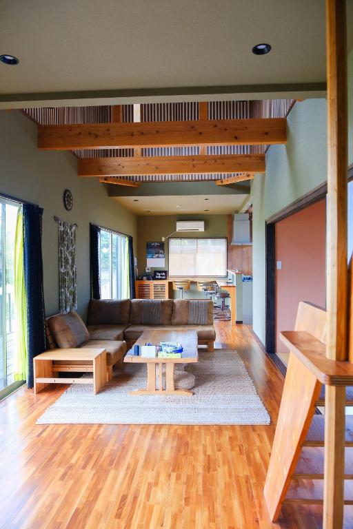 a living room with a couch and a table at スローライフ喜界 in Onozu
