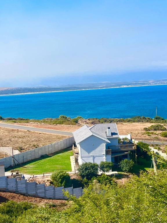 an aerial view of a house with the ocean in the background at Sea and Mountain View in Mossel Bay