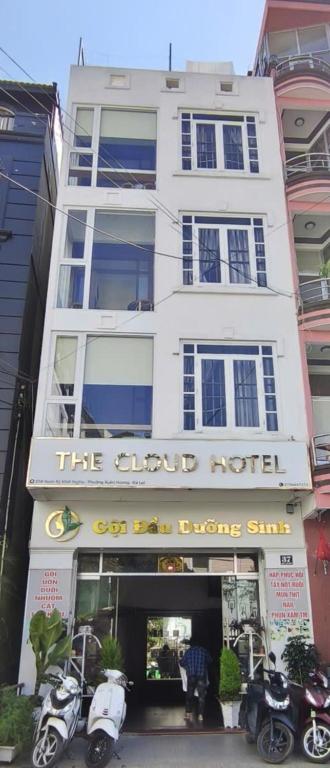 a white building with motorcycles parked in front of it at The Cloud Hotel in Da Lat