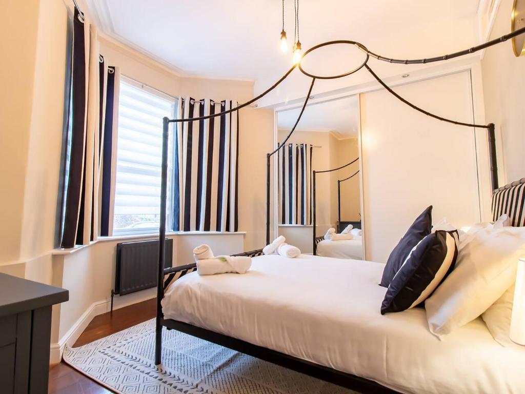 a bedroom with a bed and a large window at Grosvenor 126 Trendy Jesmond Whole Apartment in Jesmond
