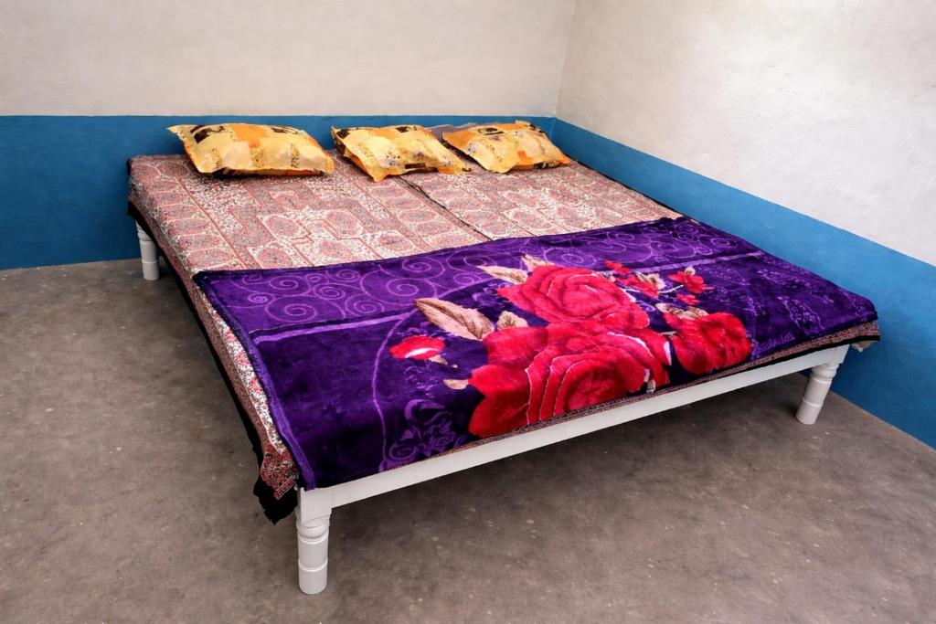 a bed in a room with two pillows on it at Mahadev Guest House in Deoghar