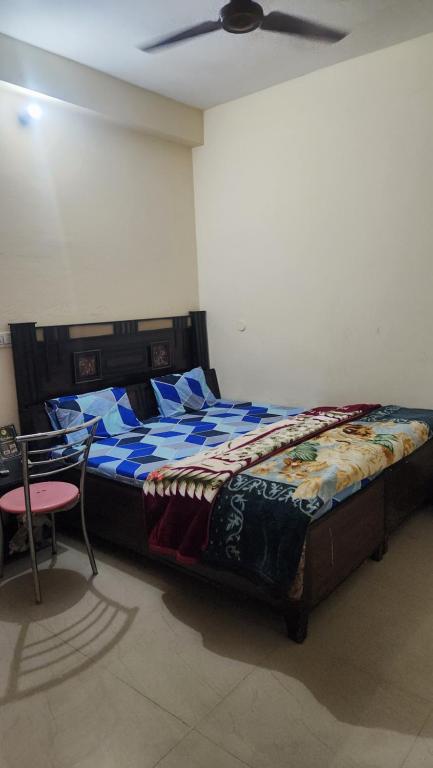 a bedroom with a bed and a ceiling fan at Krishna guest house in Mussoorie