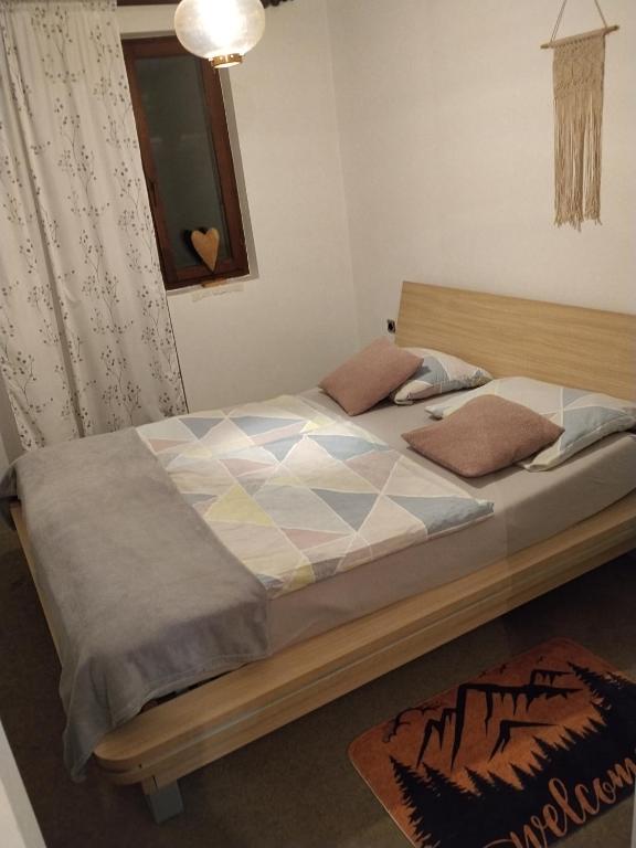 a bedroom with a large bed with at Planinski dom Kal in Dol pri Hrastniku