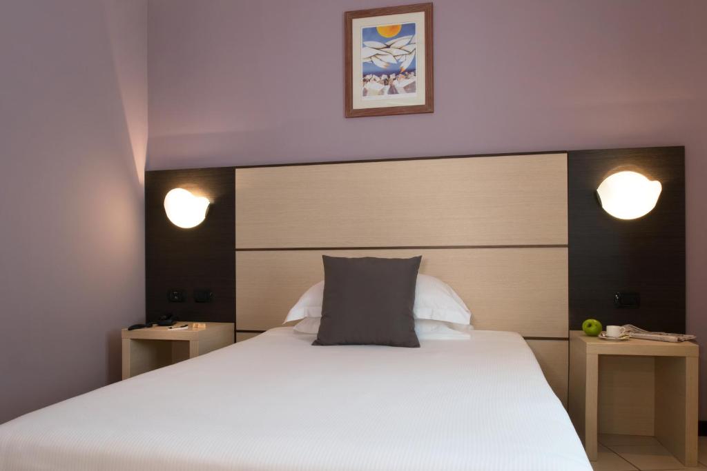 Postel nebo postele na pokoji v ubytování CDH Hotel La Spezia