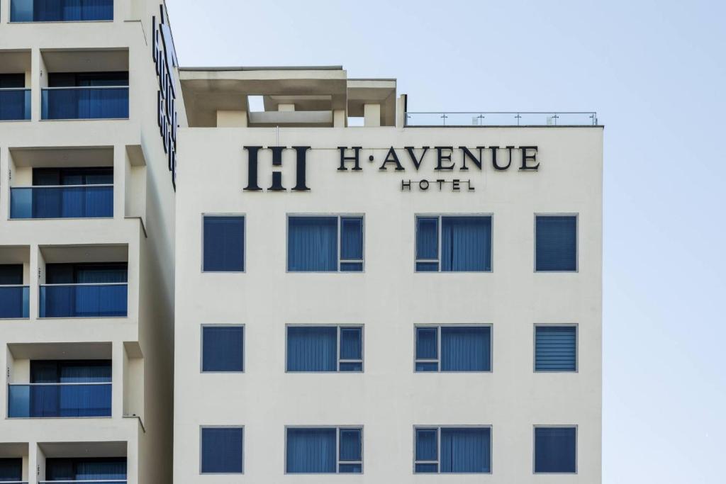 a building with a h viagency hotel sign on it at H-Avenue Hotel Yeongildae in Pohang