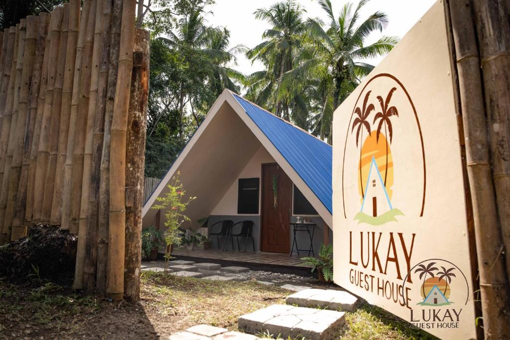 a small house with a sign in front of it at Lukay Guest House in Siquijor in Lazi
