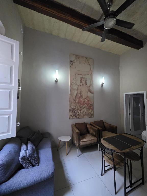 a living room with a couch and a table at Charming Valletta Escape Unesco Area in Valletta
