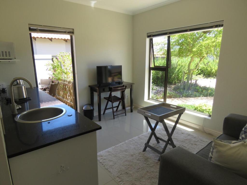 a living room with a sink and a couch and a television at the range in Langebaan
