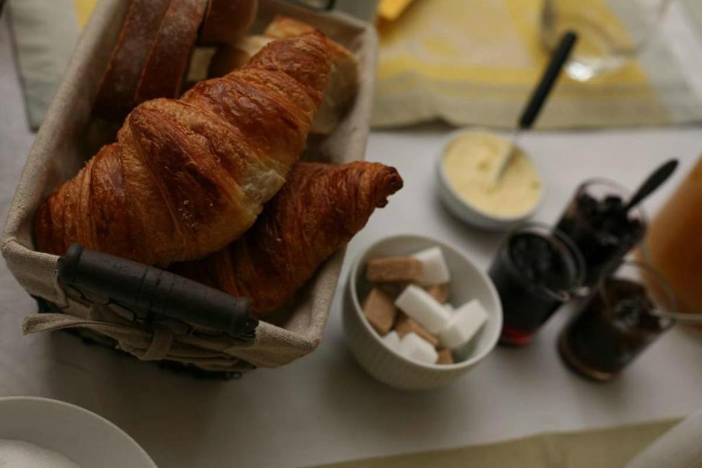 a table with a loaf of bread and a bowl of butter at Les Chambres du Beau Regard in Villé