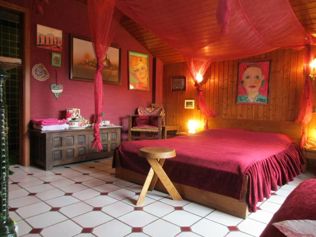 a bedroom with a bed and a table in it at Tilly's B&B and apartment house in Le Hohwald