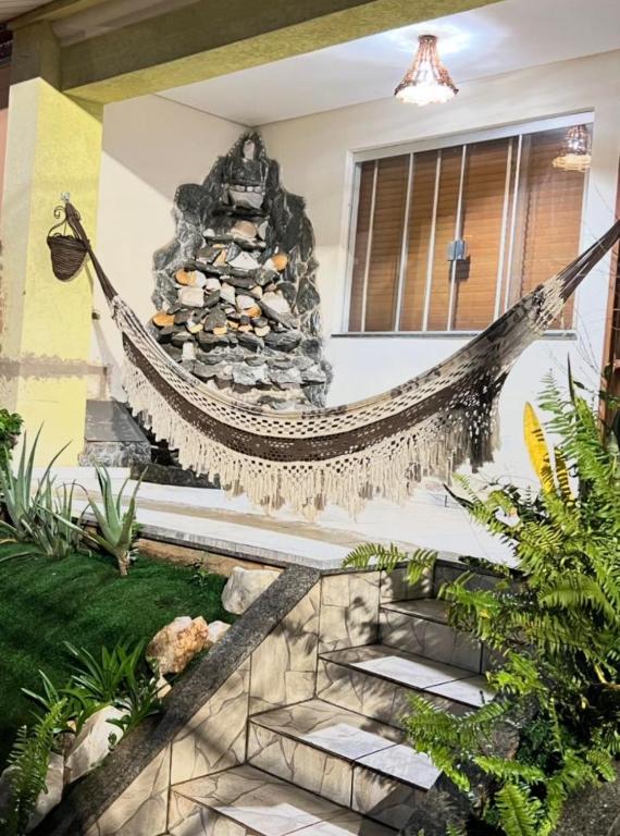 a hammock hanging off the side of a house at Hostel Sideral in Campo Grande