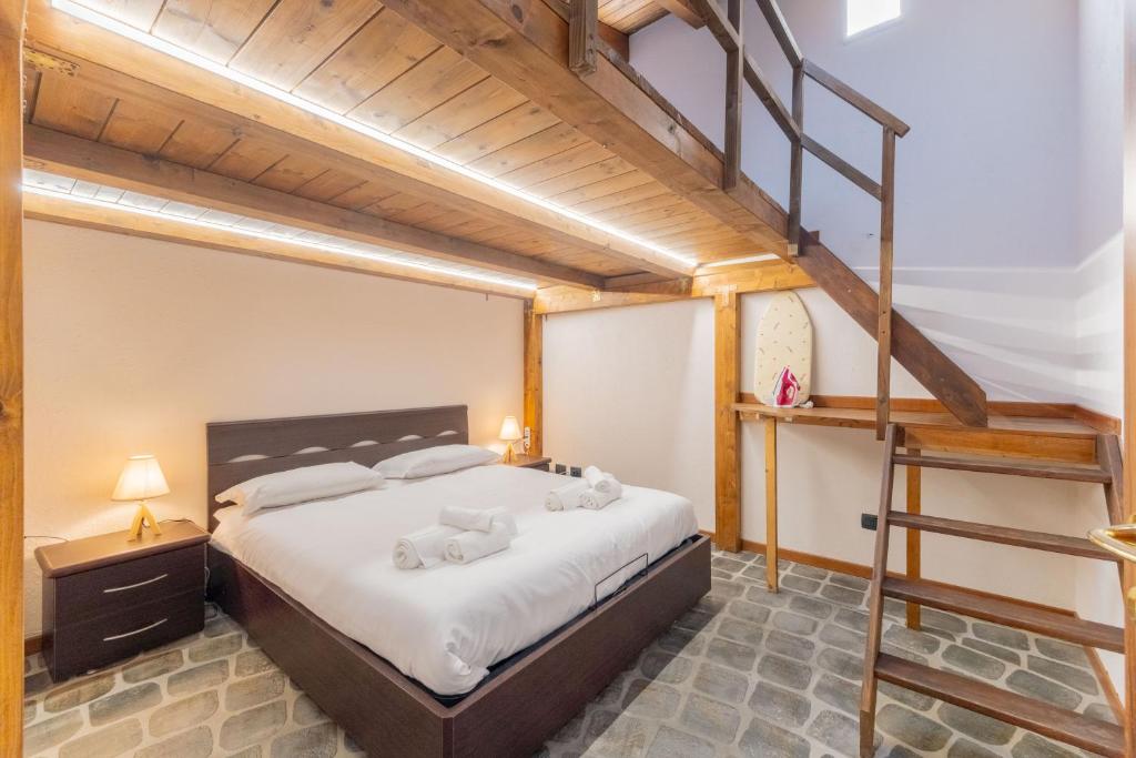 a bedroom with a loft bed with a ladder at EasyHome Malpensa Milano - self-check-in in Somma Lombardo