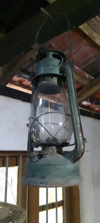 a green light hanging from a ceiling at Lakeview since 1963 in Pilawala