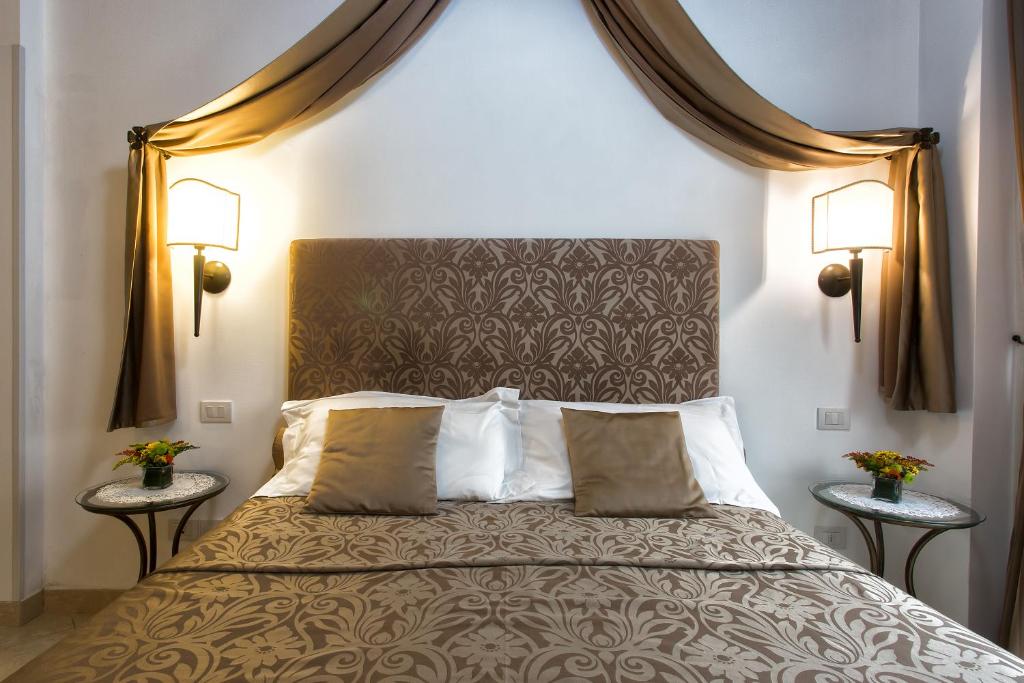 a bedroom with a large bed with two tables at Alla Vite Dorata in Venice