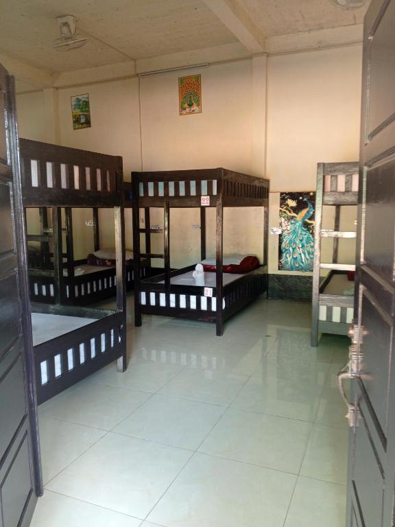 a room with three bunk beds in a room at Dormitory Hostel Cam Uo in Nongkhiaw