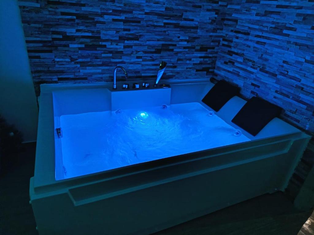 a blue bath tub with a sink in a room at B&B La Perla & Suites in Bari