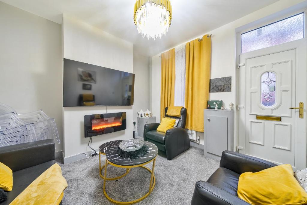 a living room with a couch and a fireplace at Contractor-friendly Home in Stoke with Free Parking in Stoke on Trent