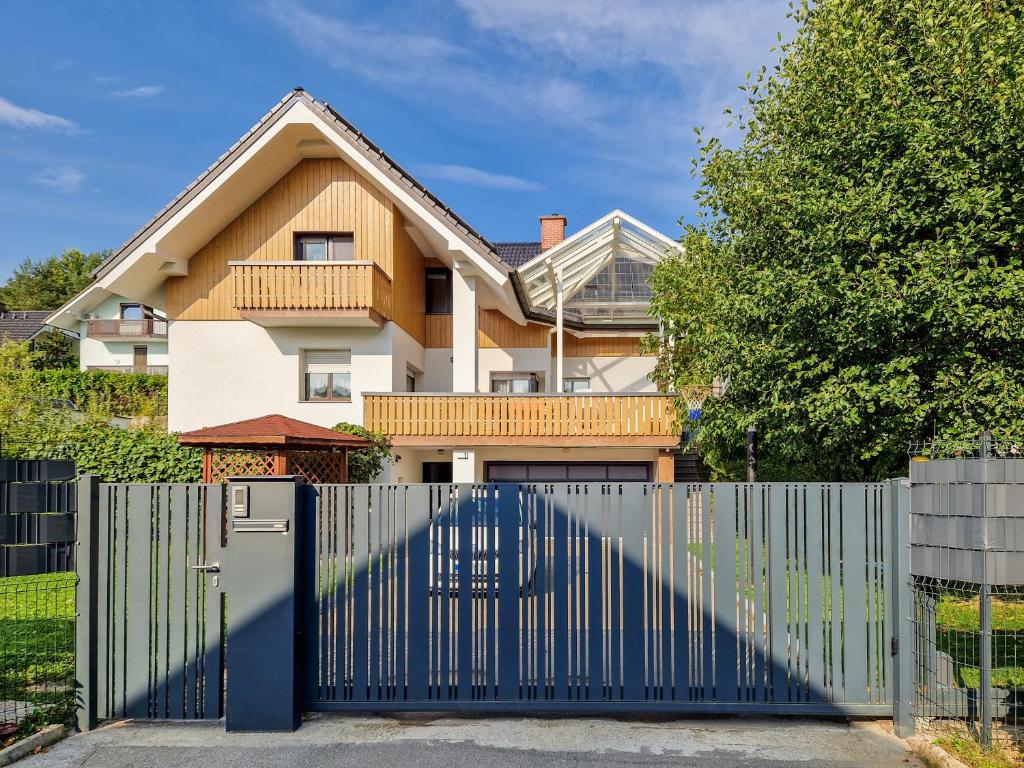 a blue gate in front of a house at Green View Kamnik in Kamnik
