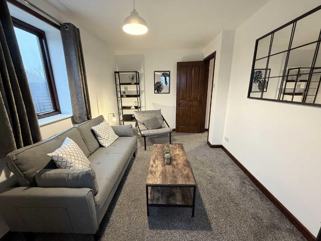 a living room with a couch and a coffee table at Millbrook House Apartments 7 in Milton