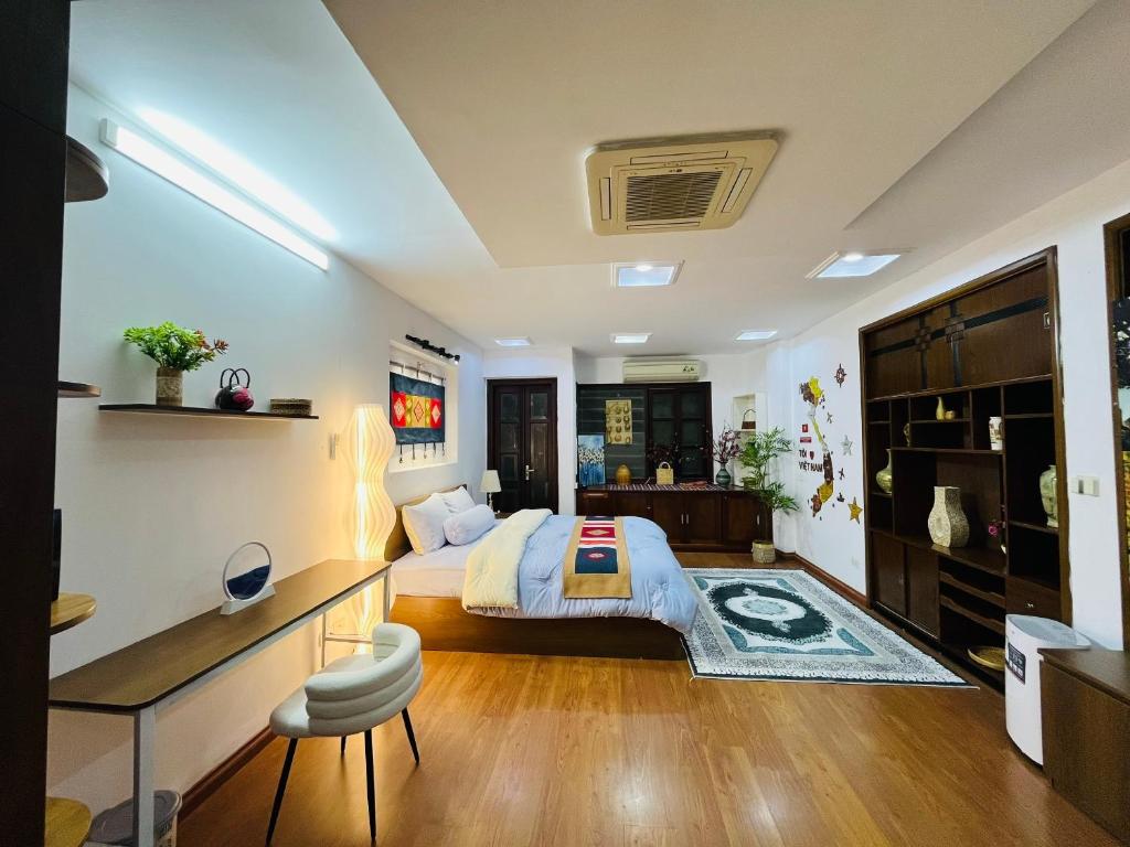 a bedroom with a king sized bed and a desk at Kim's Home in Ba Dinh in Hanoi