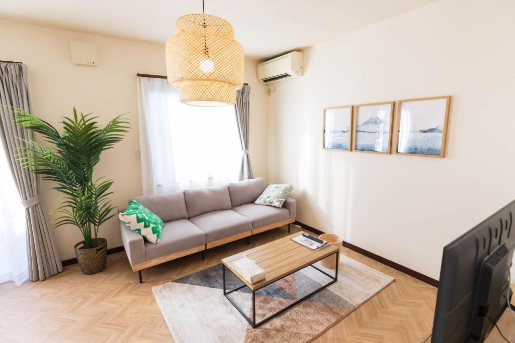 a living room with a couch and a table at Fuji Life House in Fuji
