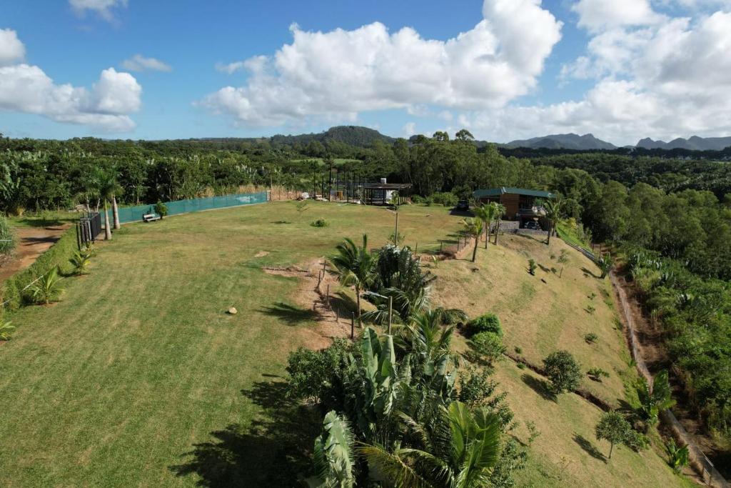 an aerial view of a large field with a house and a river at The Serenity in Mauritius