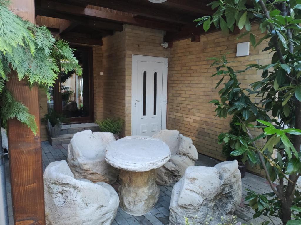 a stone table in front of a house with rocks at BpR P3 Lodge Apartment with A/C in Budapest