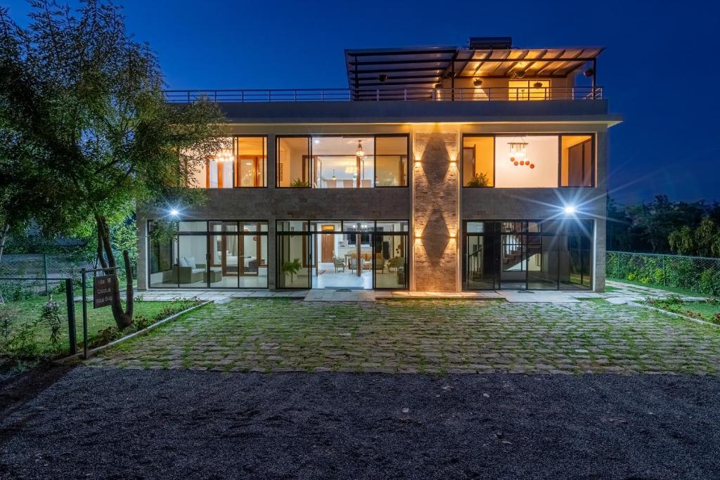 a large house at night with lights at OSOTUA Villa 18 Home Hotel Nanyuki 7 Bedrooms 14 Guests in Nanyuki