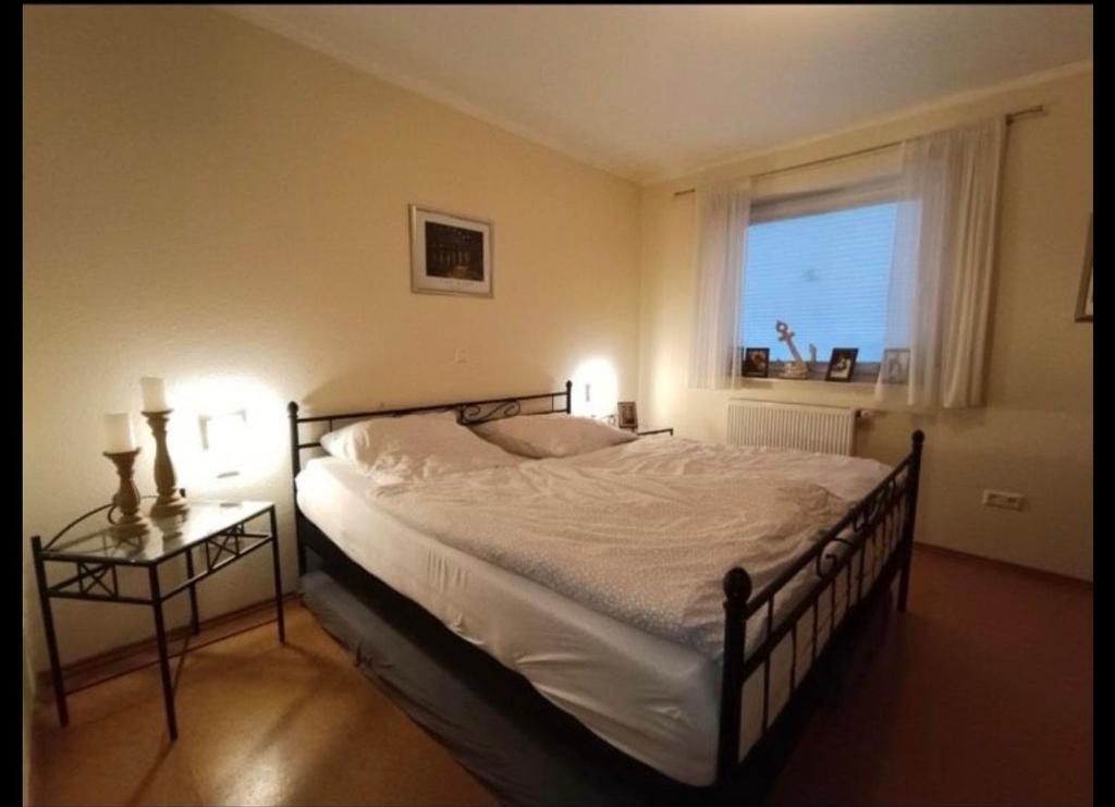 a bedroom with a large bed and a window at Kinderparadies Norddeich in Norddeich