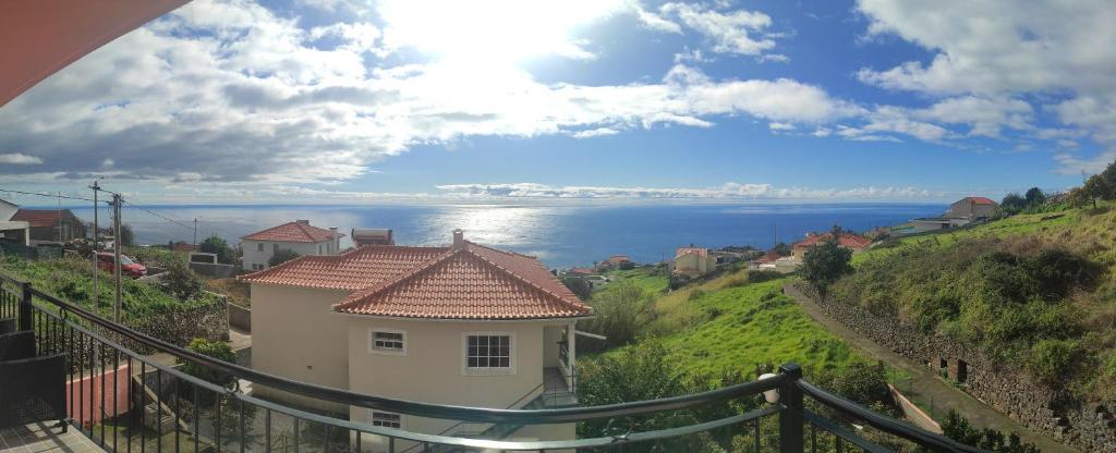 a house on a hill with a view of the water at Golden Sun Refugio -Calheta in Estreito da Calheta