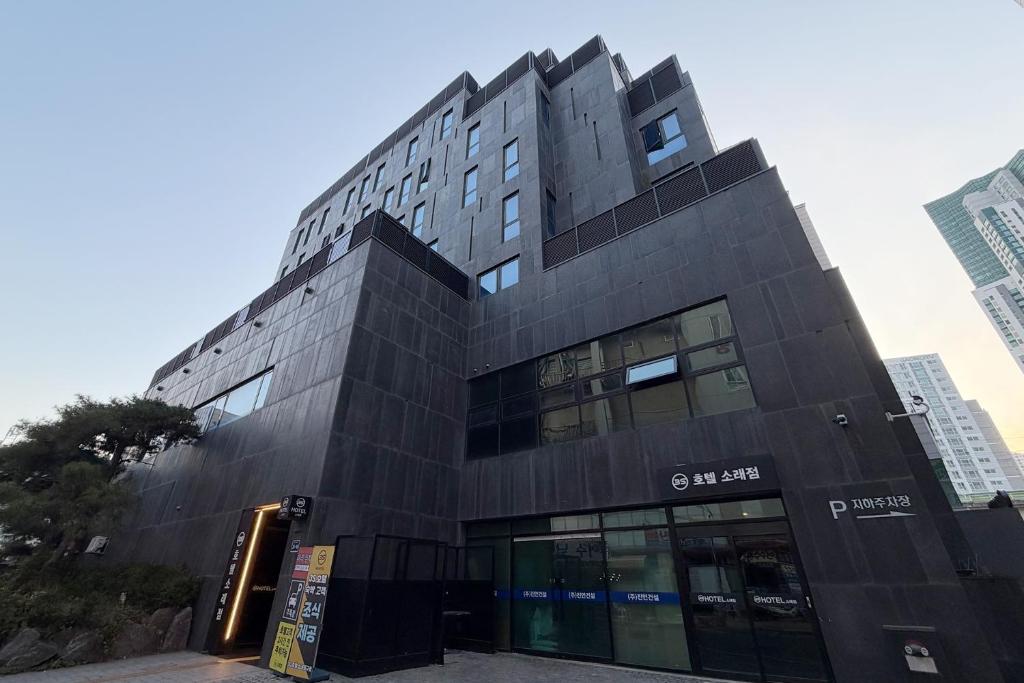 a tall black building in a city at 3S HOTEL 소래포구점 - sorae port in Incheon
