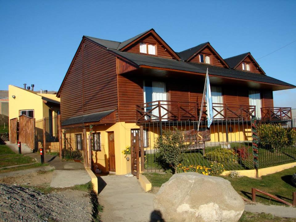 a large wooden house with a gambrel roof at Cabañas Marias del Sur in El Calafate