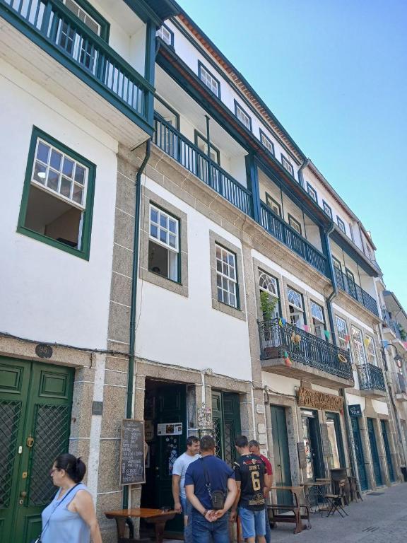 a group of people standing outside of a building at Casa Kilowatt - Amarante in Amarante