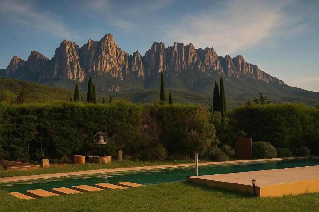 a swimming pool with a mountain range in the background at LuxRural Montserrat | Piscina con Vistas Únicas in Marganell