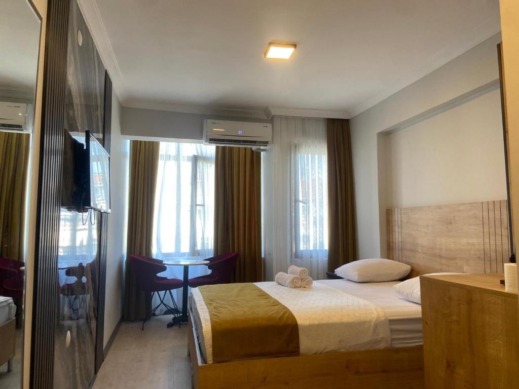 a hotel room with a bed and a desk in it at Güven Suit Otel in Istanbul
