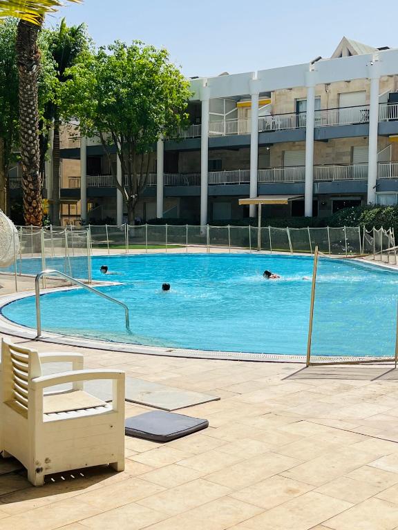 a swimming pool in a building with people swimming in it at Royal Park A&7 Deluxe, swim pool - by G&P suites in Eilat