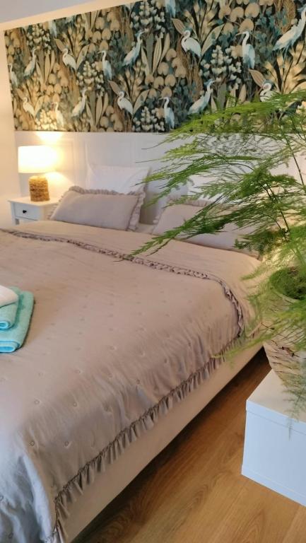 a bedroom with a large bed with a floral wallpaper at Las i Woda in Lubin