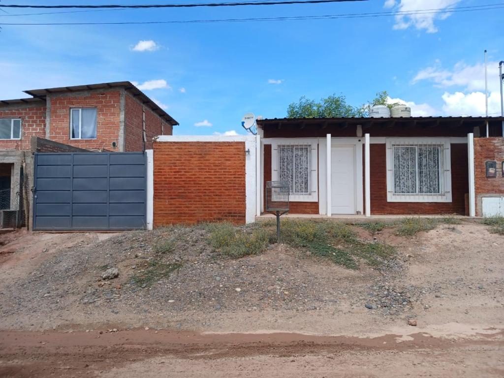 a brick house with a black garage at Casa 1 in Rincon de los Sauces