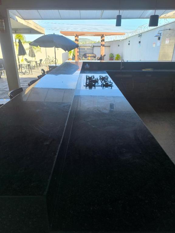 a table with a reflection of an umbrella on it at Espaço de eventos dorneles in Senador Canedo