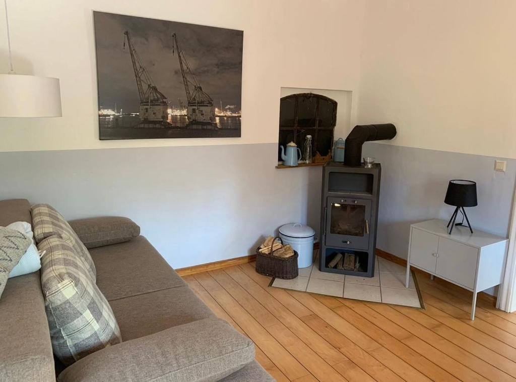 a living room with a couch and a fireplace at FEWO im Ortskern in Gudow