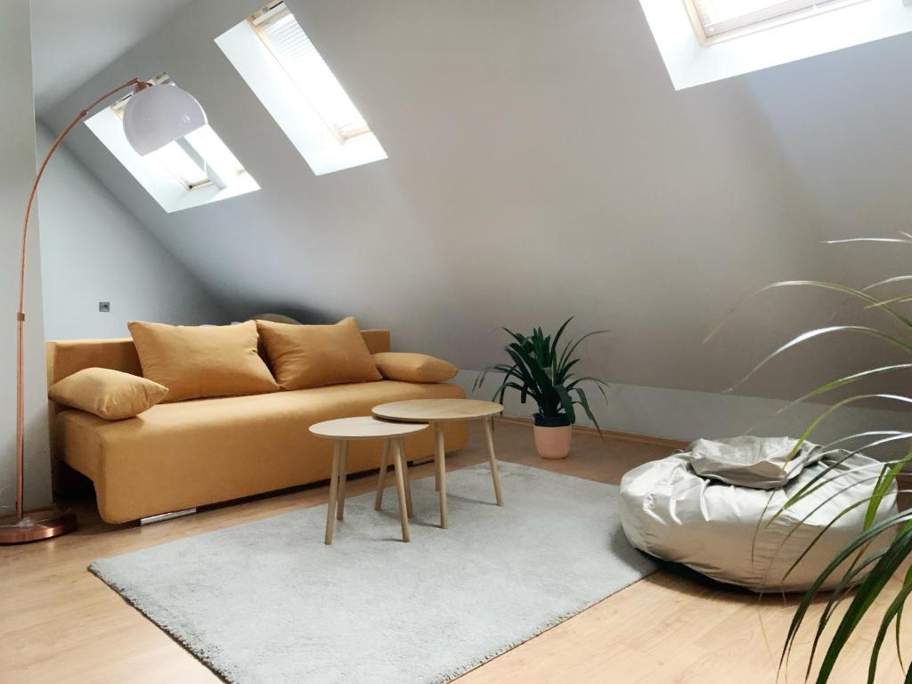 a living room with a couch and two tables at Altavista mountain apartment in Samokov
