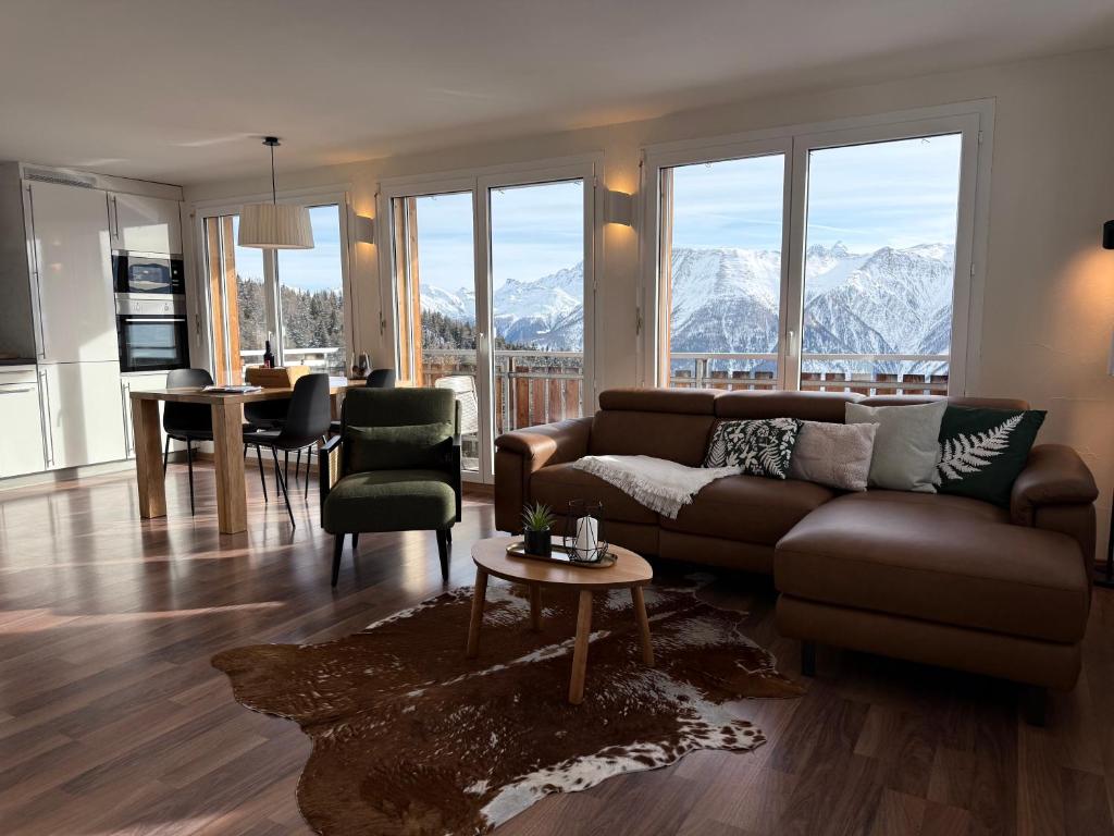 a living room with a couch and a table at Bergquelle 2. OG in Bettmeralp