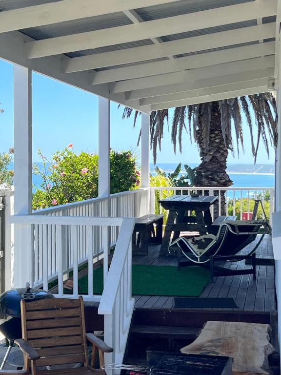 a porch with a table and a tree at Brenton Bliss 3-N in Brenton-on-Sea