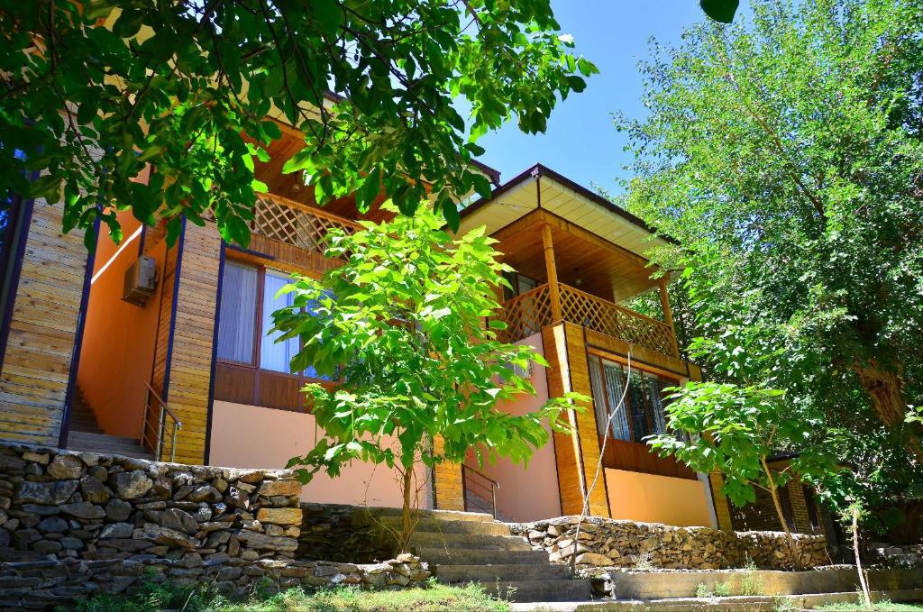 a house with stairs in front of it at Uhum Mountain Guesthouse in Yukary-Ukhum