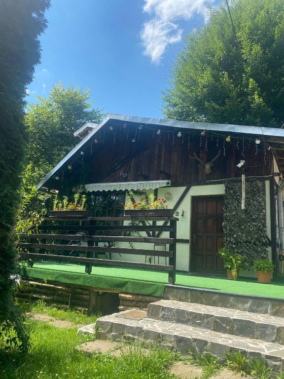 a house with a porch and stairs in front of it at Chalet Traian & Ruxandra in Sinaia