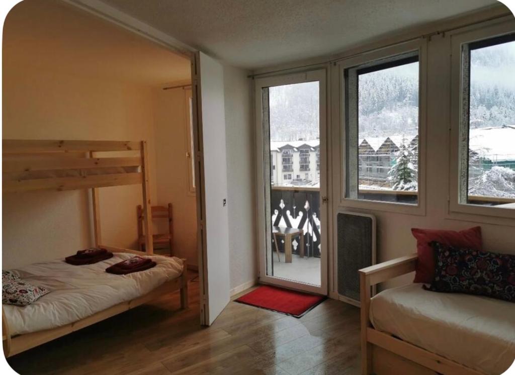 a bedroom with a bunk bed and a window at Jonquille 5 personnes in Chamonix