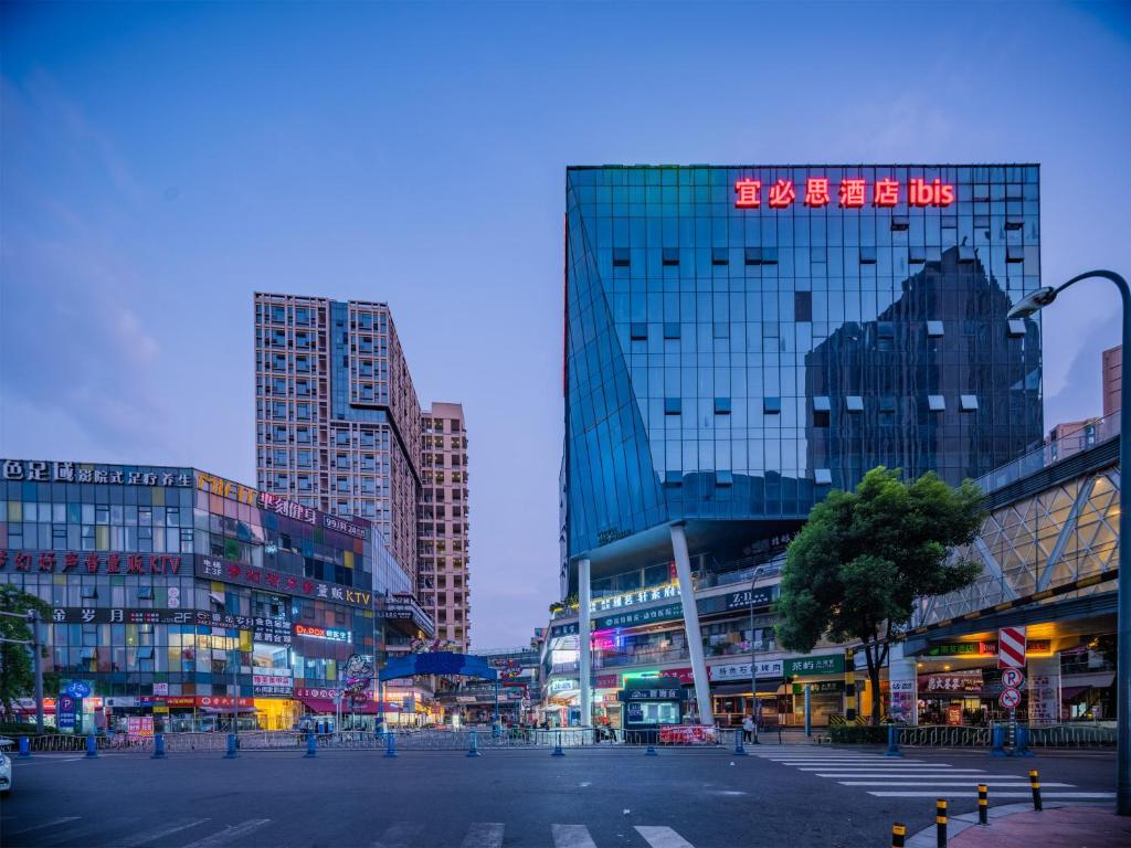 a city with tall buildings and a street at night at Ibis Chengdu High-tech Electronics University in Pi